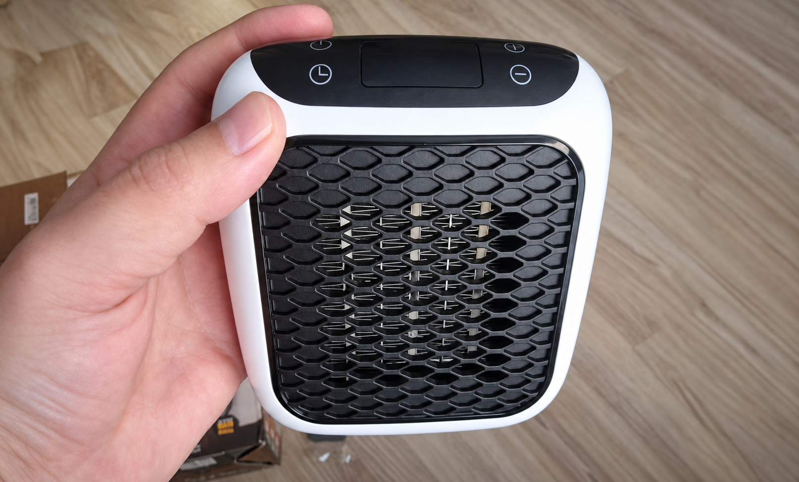 WellHeater held in one hand to show its compact size — wellheater reviews